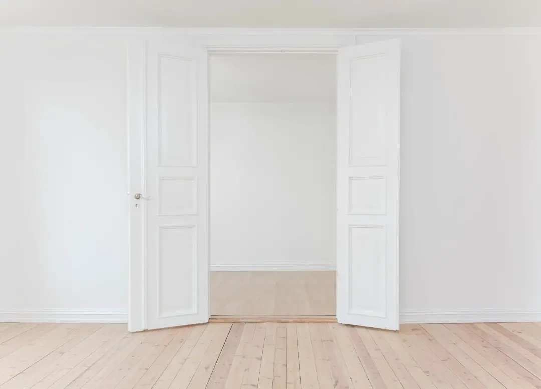 Door in a white room by Guitar Brands minimalist photography of open door