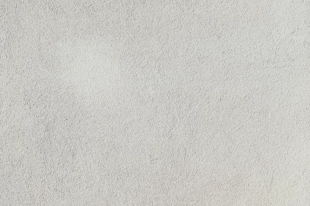 a close up of a white stucco wall