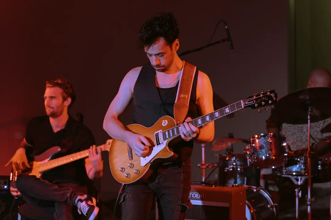 A group of men playing guitars on stage