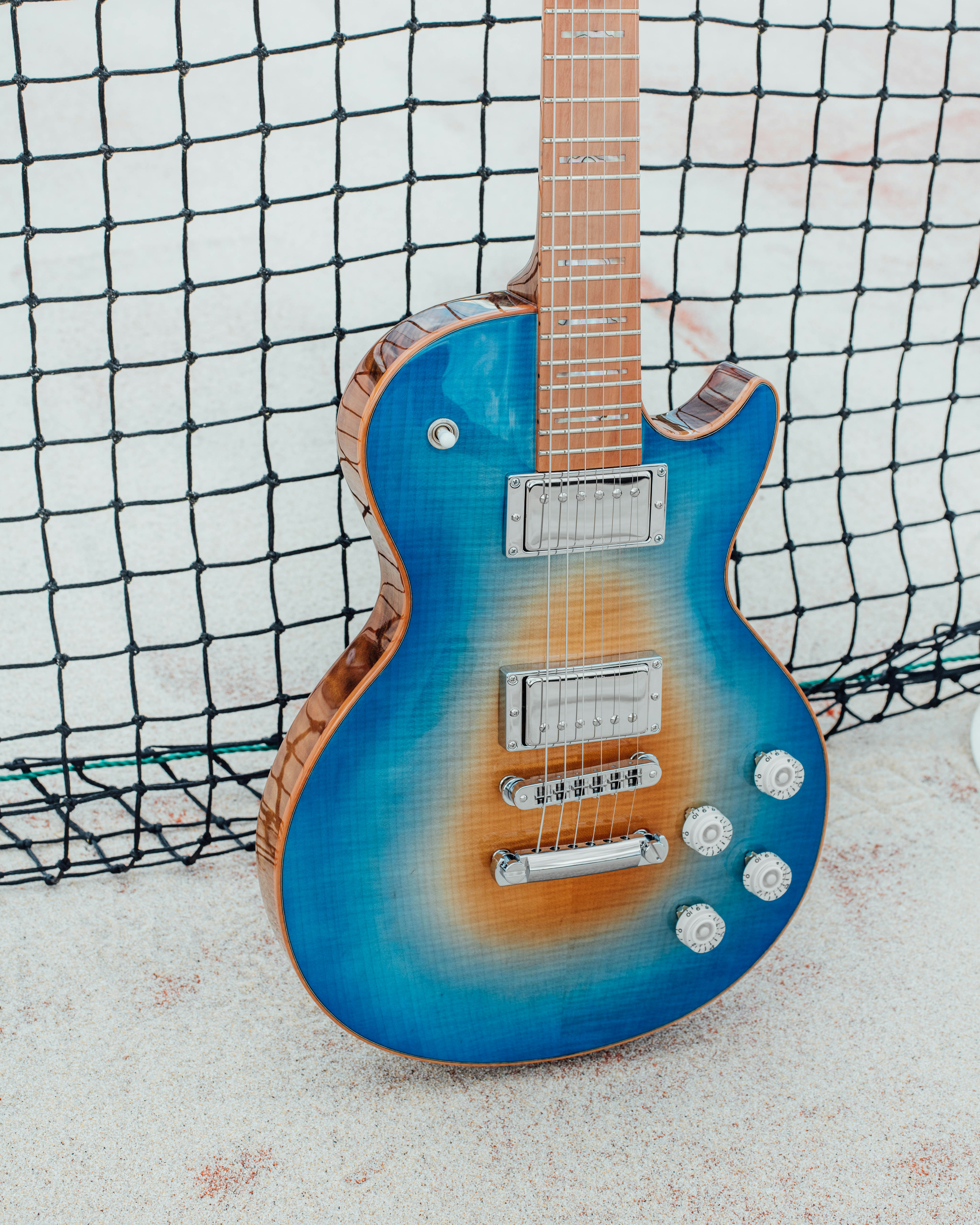 blue and brown electric guitar