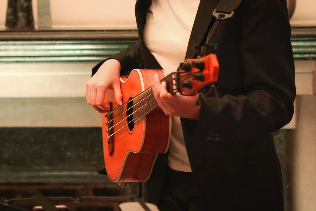 Someone is playing the ukulele in formal wear.