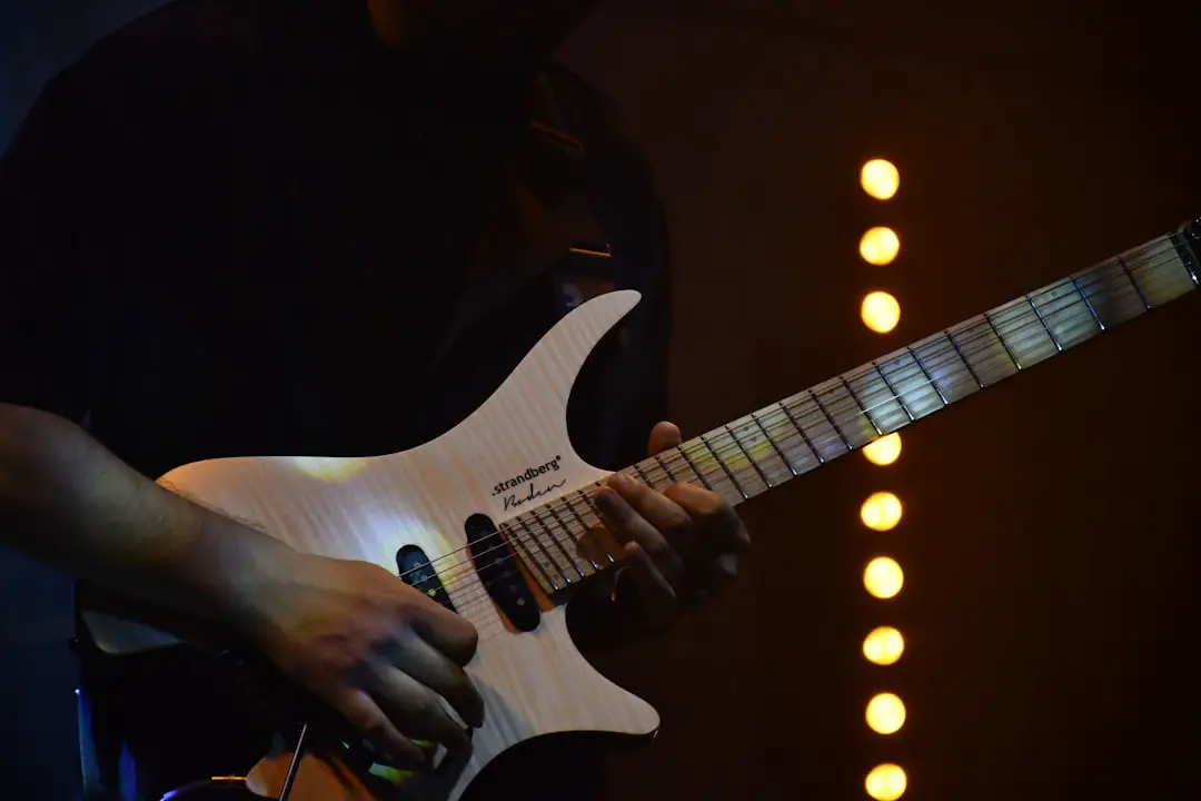 A musician plays an electric guitar on stage.